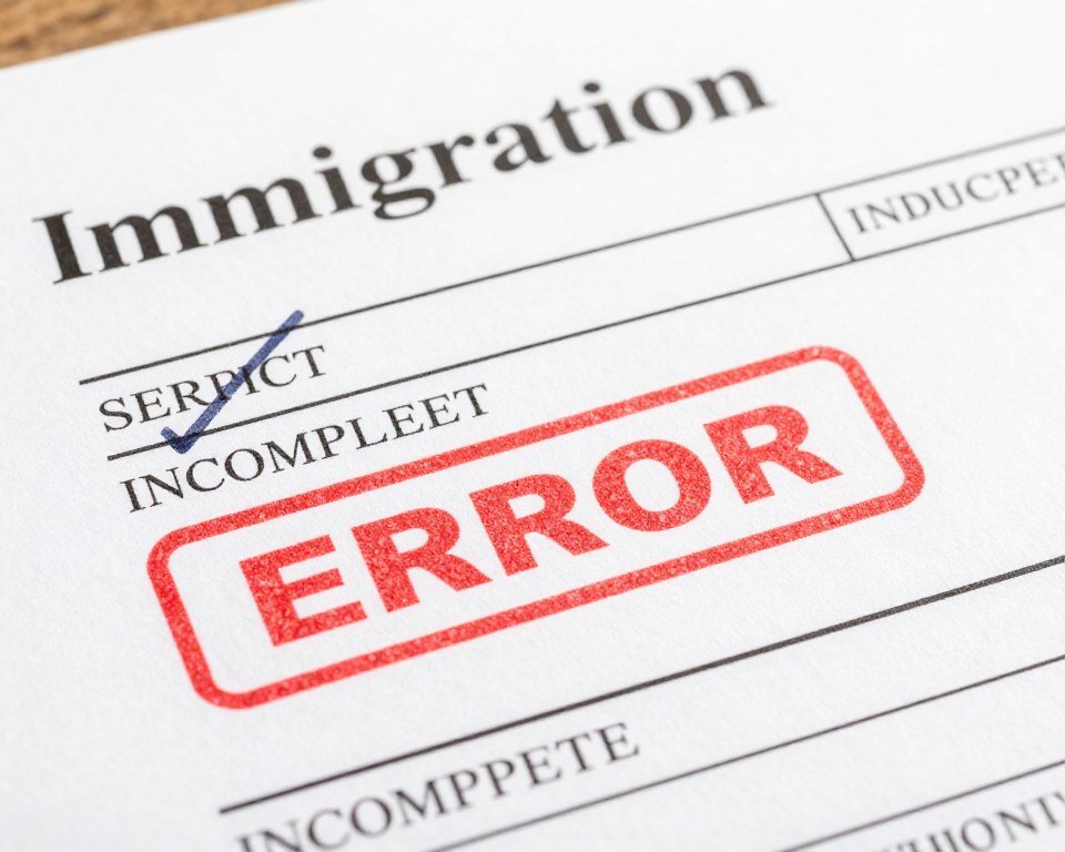 red warning stamps on immigration documents showing common errors